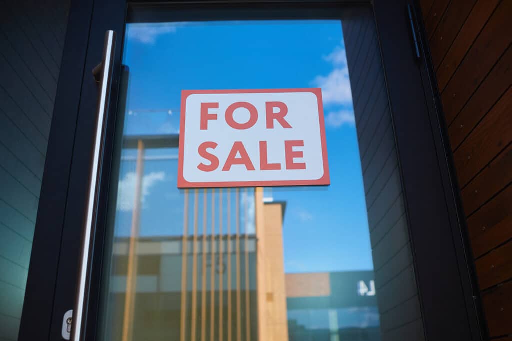 For Sale sign on a glass door